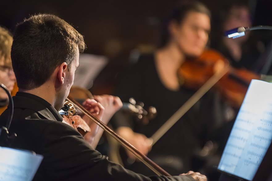 Man playing violin in concert