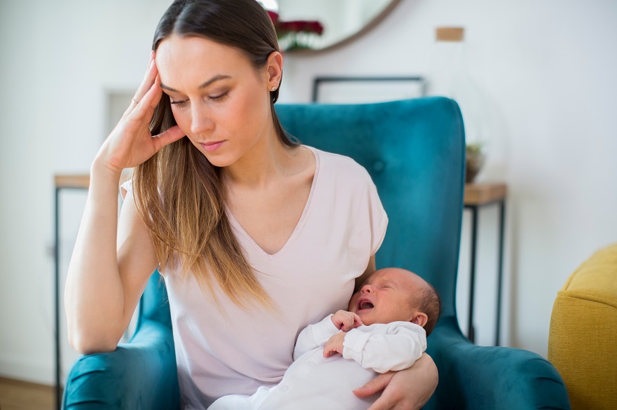 Stressed Mother Holding Crying Baby