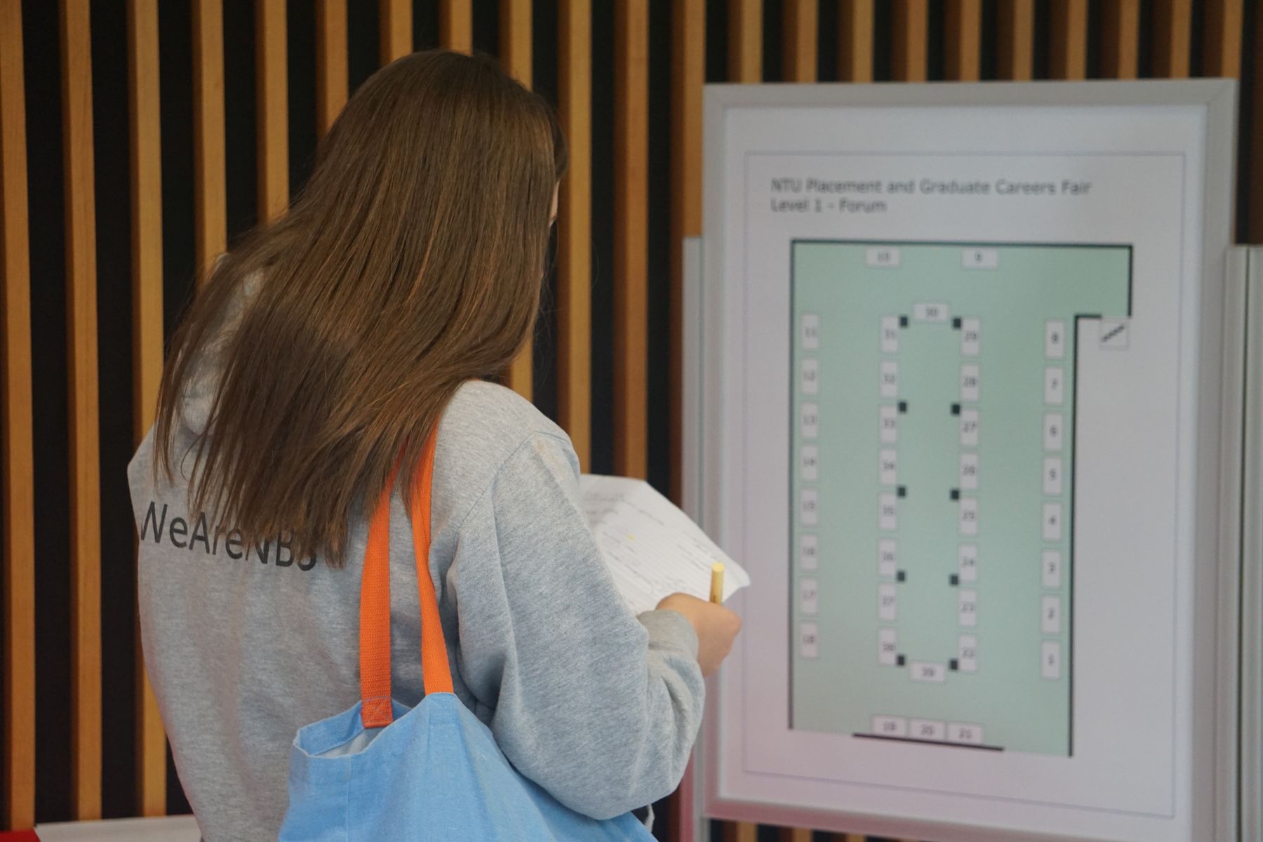 Student looking at careers fair stand map