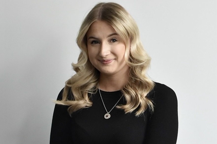 A person smiling, facing the camera.