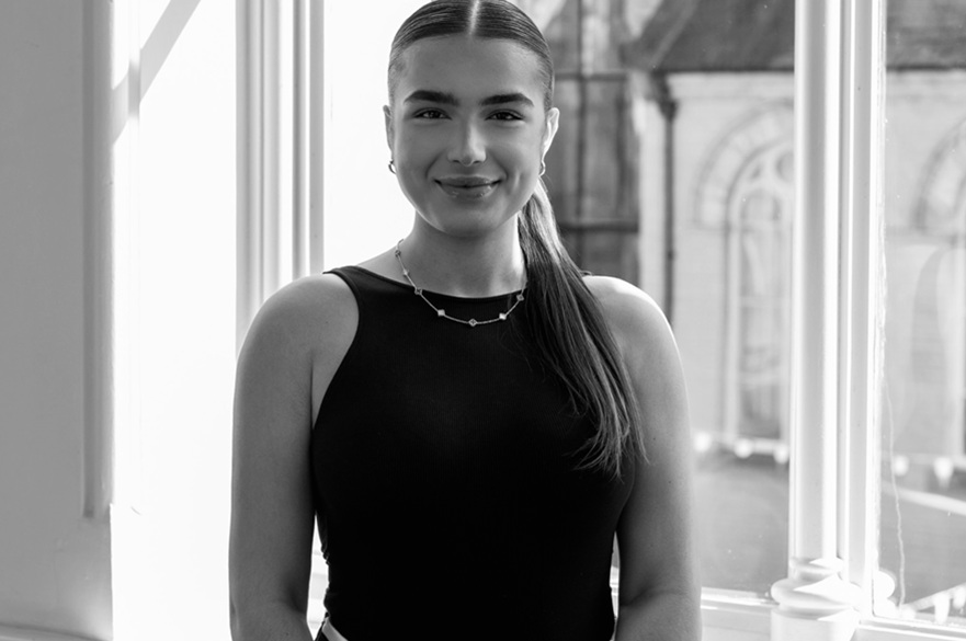 A person facing the camera, smiling for a photograph.