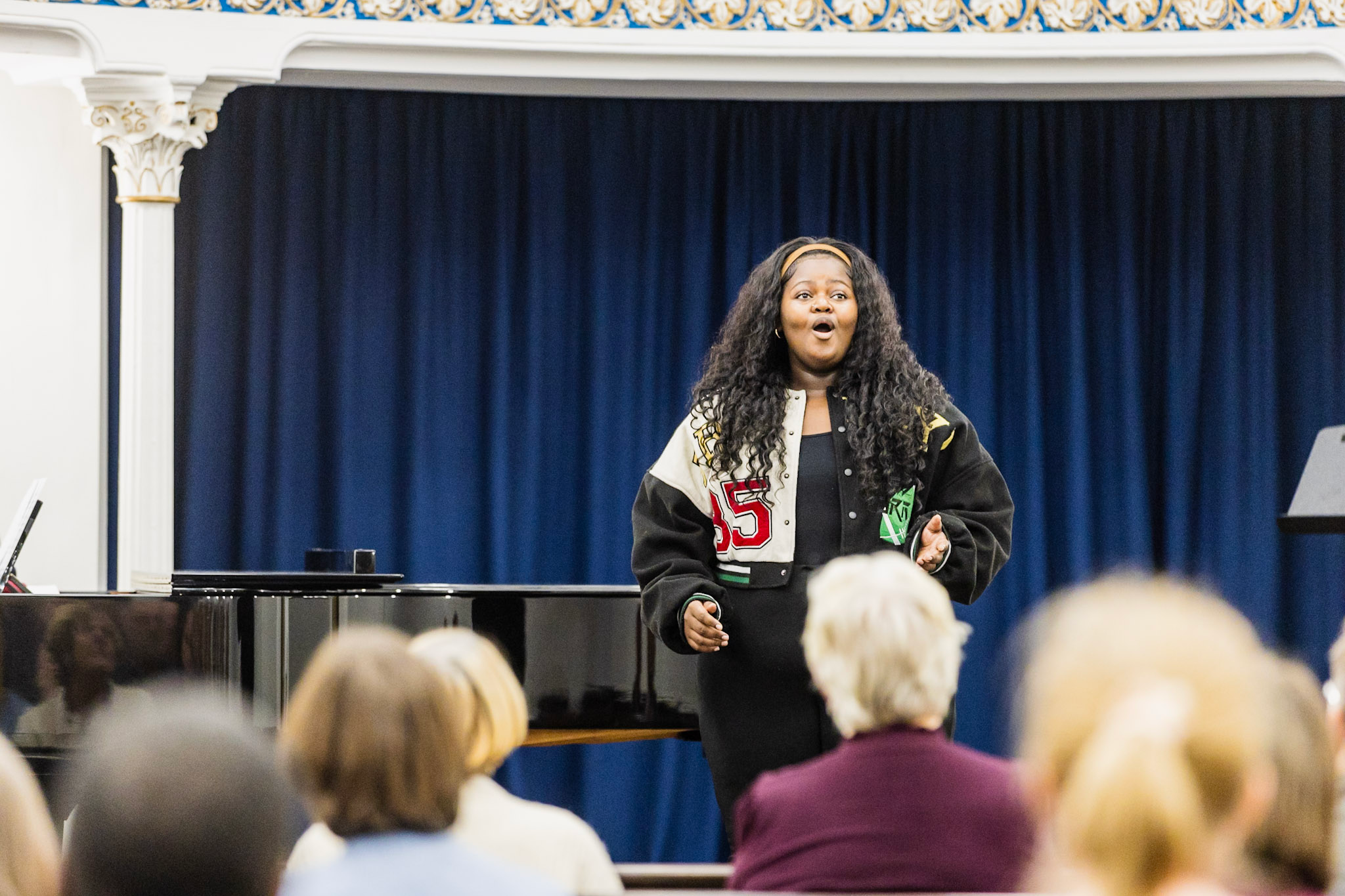 A black woman singing.