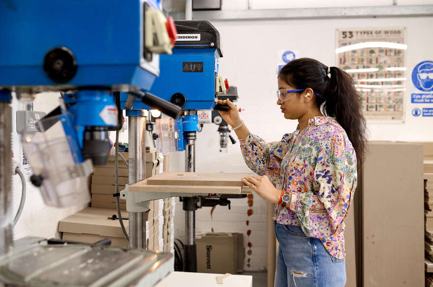 Student using pillar drill