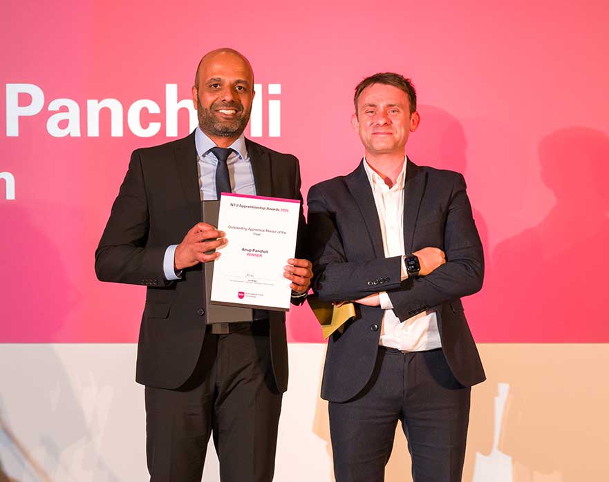 Anup receiving his award on the NTU stage