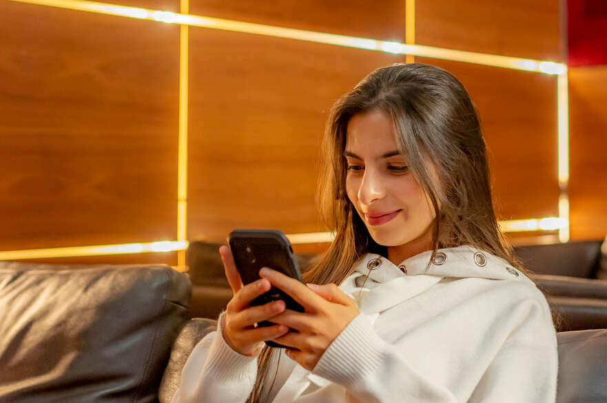 A student sits looking at a phone