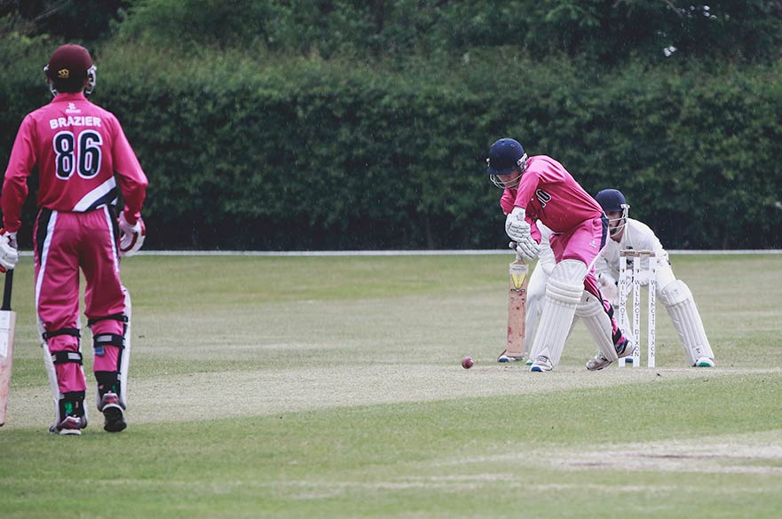 3 people playing cricket