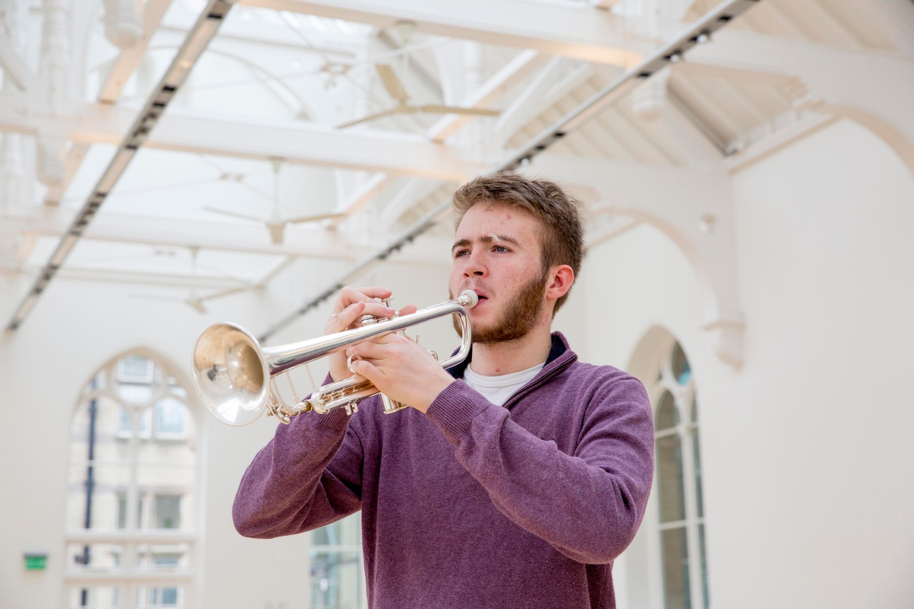 Male student playing trumpet