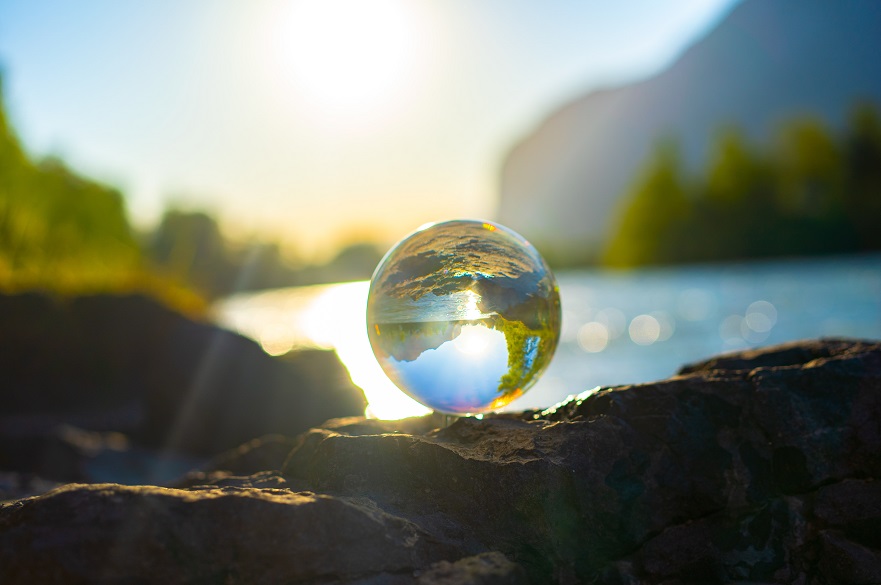 glass ball reflecting a lake