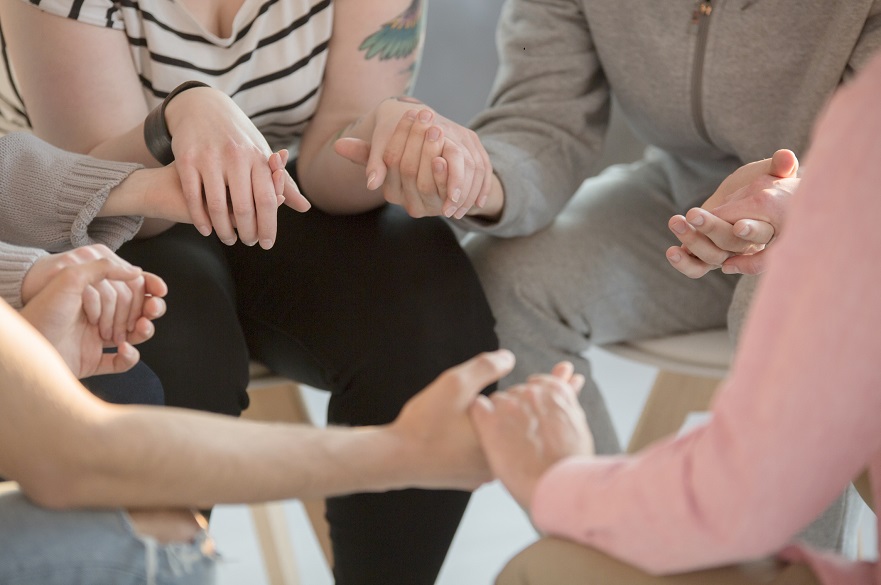 People holding hands in a circle