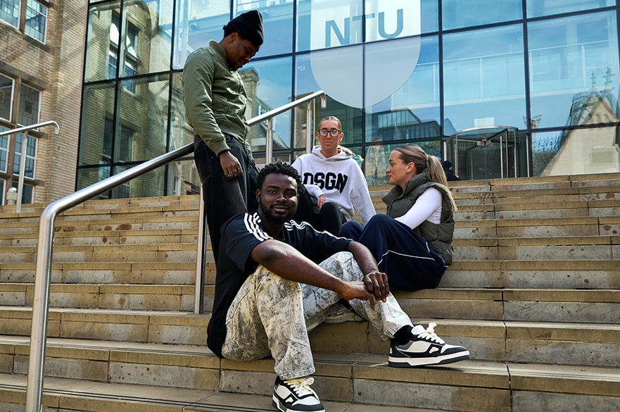 Four students sit outside at NTU's Benefactors Court