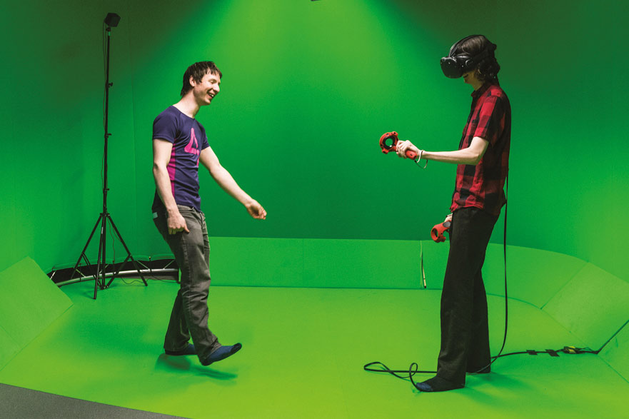students in green screen room