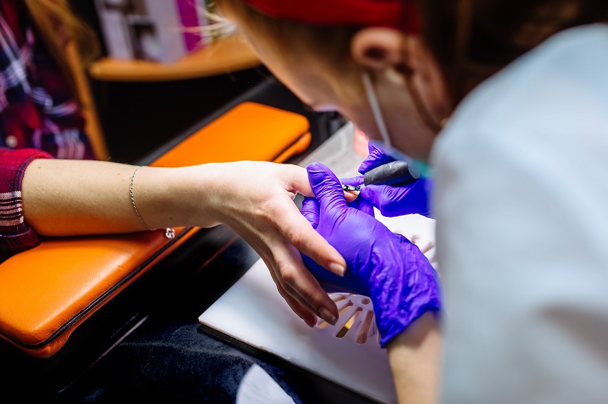 Nail care in salon. Selective focus on customer's nails