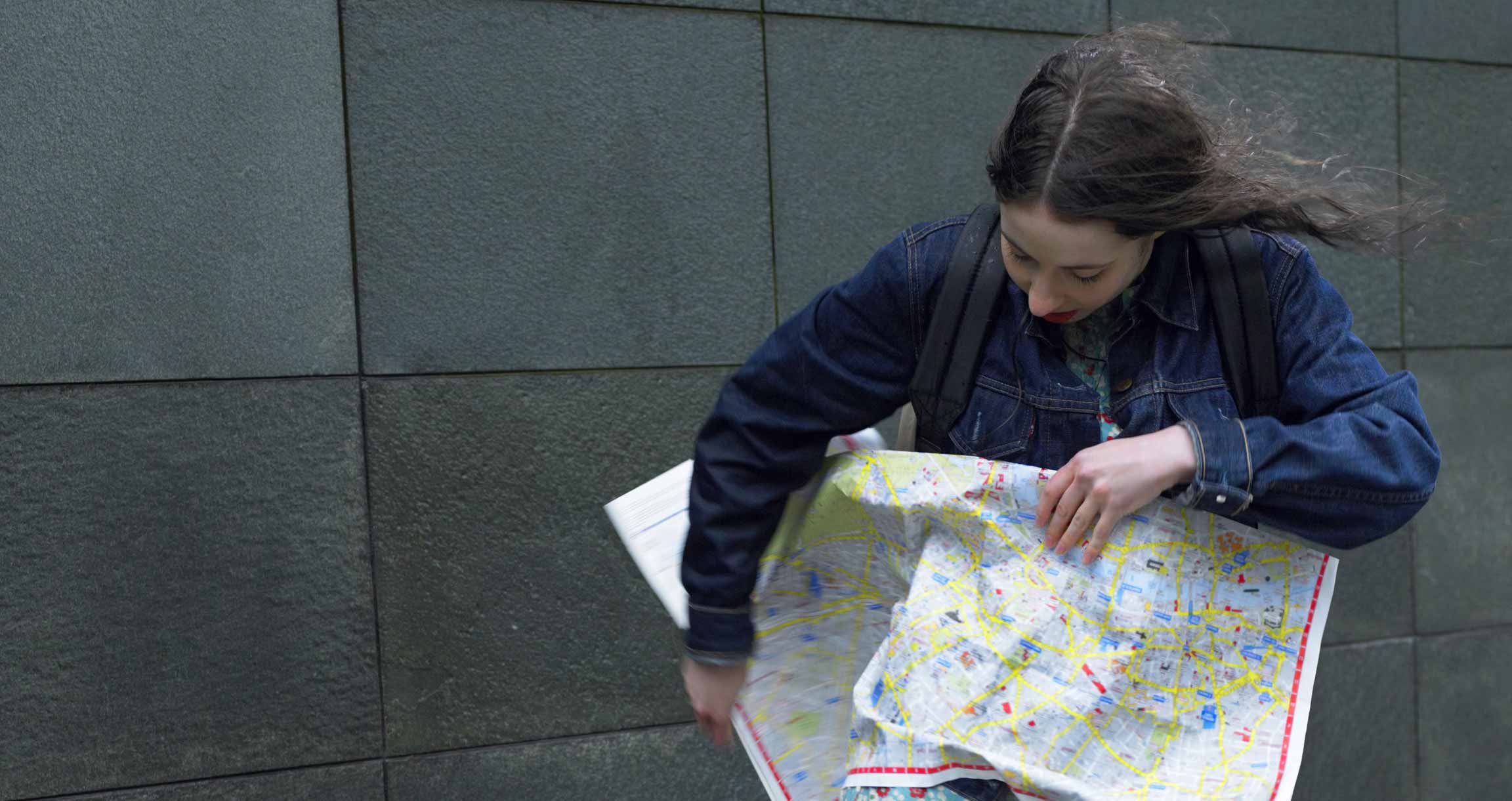 Girl looking lost with a map