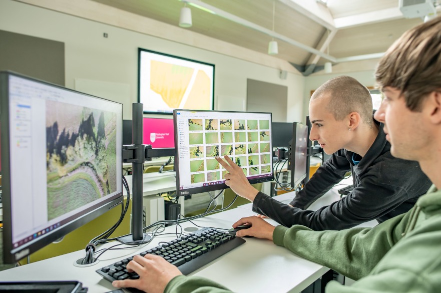 Two students use GIS software to analyse drone data in our specialist GIS computer suite