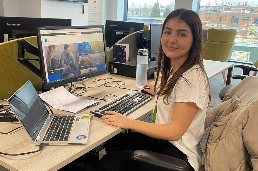 Danielle Thompsett at her work desk with computer 