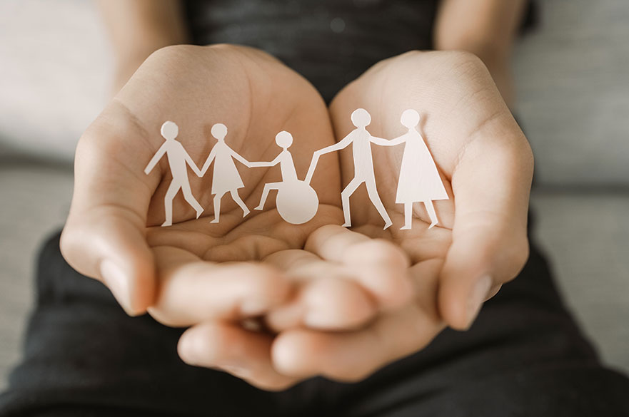 Hands holding diversity family, happpy carer and volunteer, disable nursing home, rehabilitation and health concept