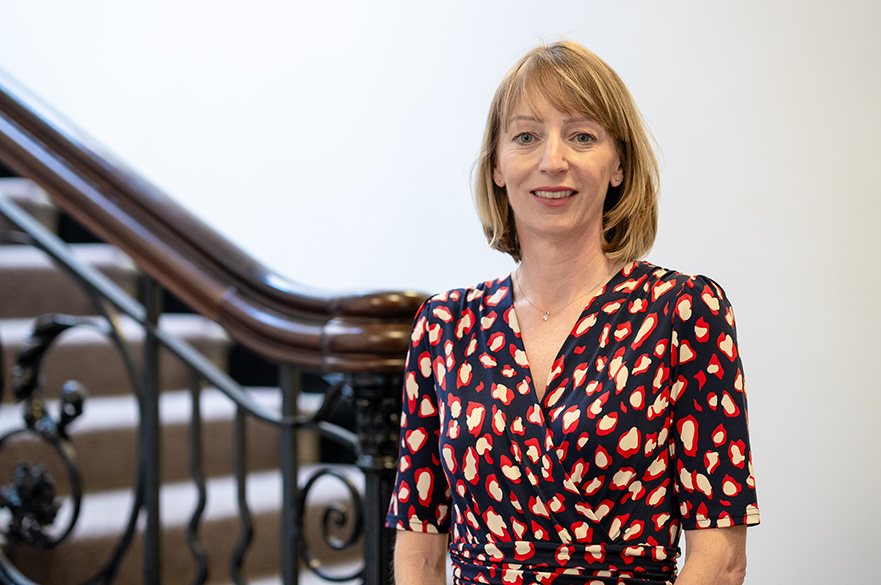 Katie Worgan, a member of the Board of Governors, wearing formal attire and posing for a professional portrait