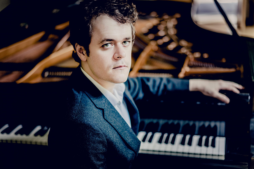 Benjamin Grosvenor sat at a piano.