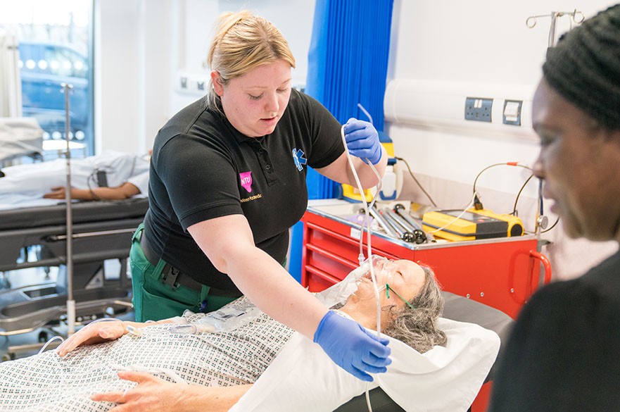 Paramedic Science student during practical session in ward with lifelike mannequin