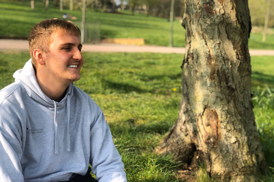 Billy smiling in a park