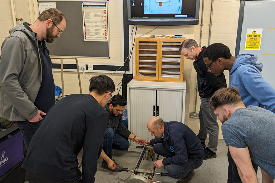 Students and academics working together inside of NTU's Geotechnical lab