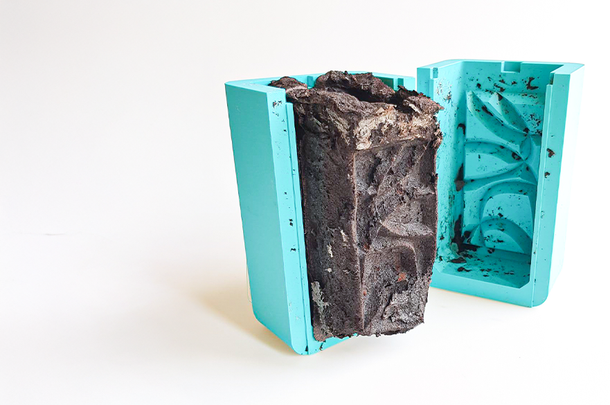A mould being used to shape a biomaterial into an artisan container.