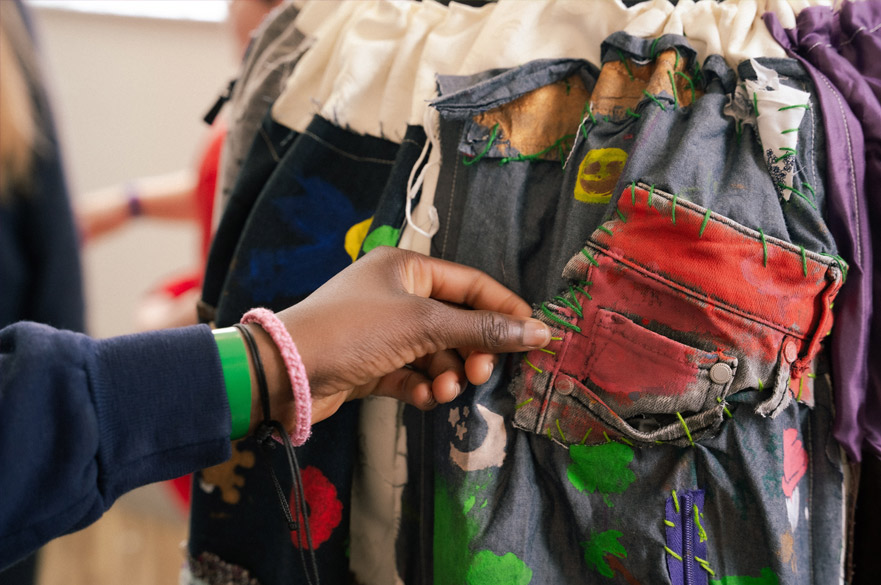 A hand touching a handmade garment