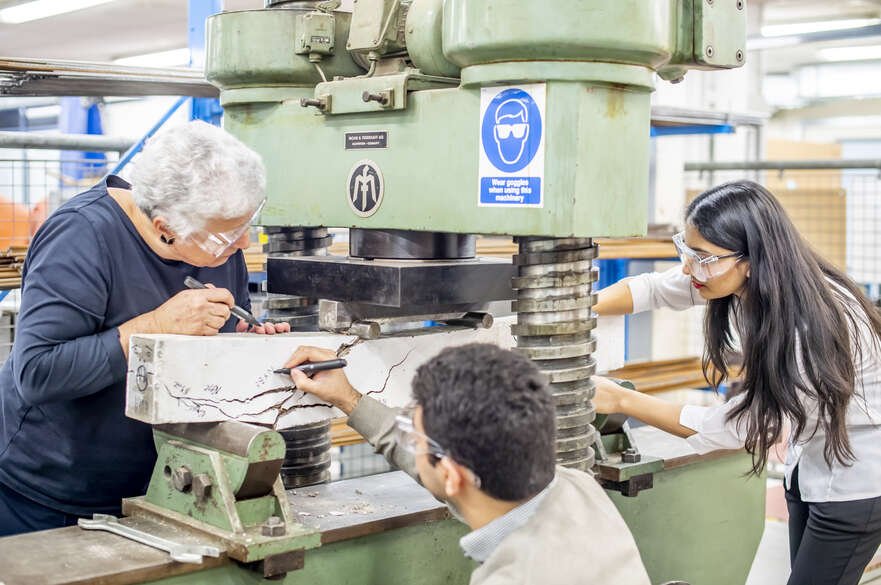 Students using structural testing equipment