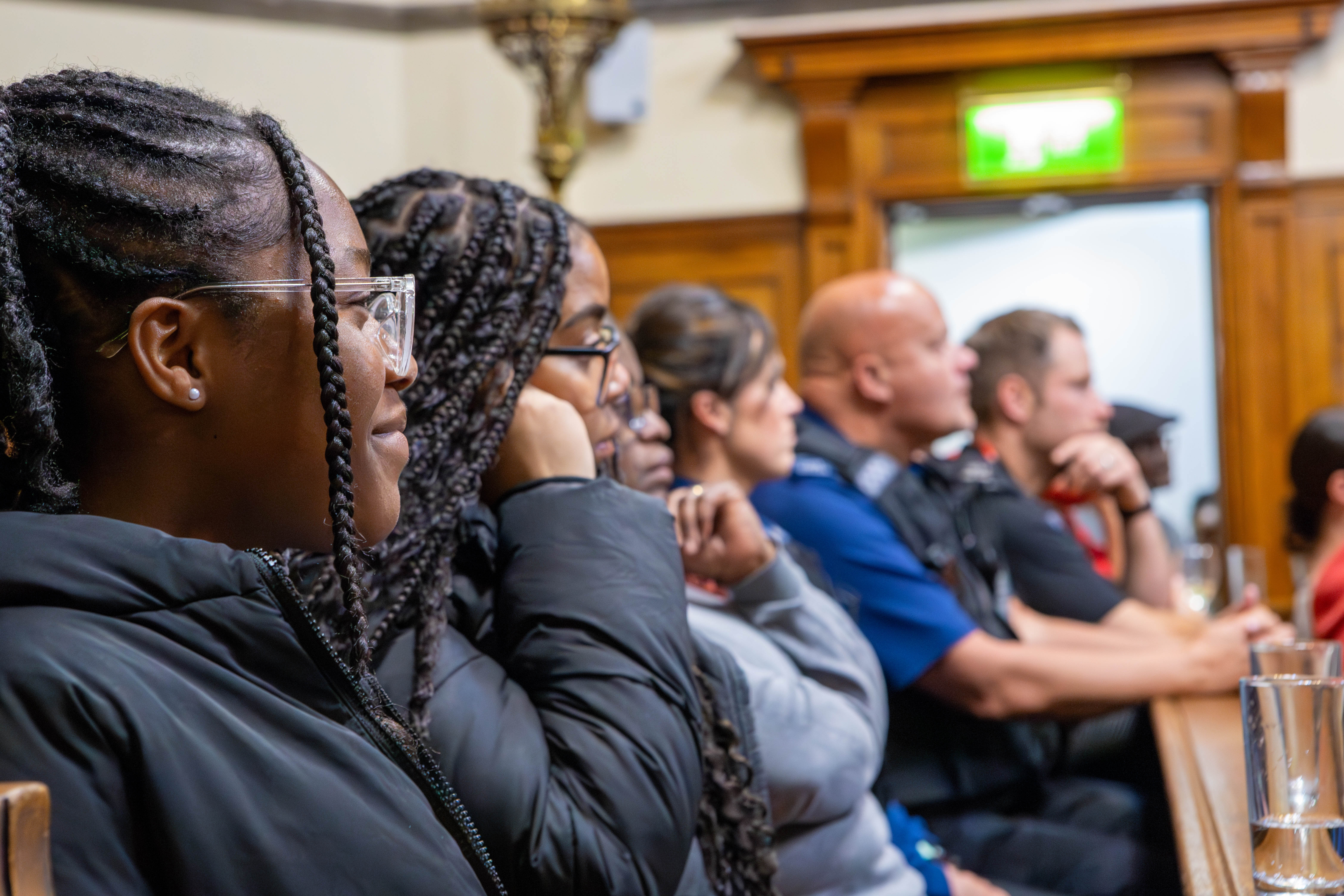 Young people sitting with police in court room of National Justice Museum
