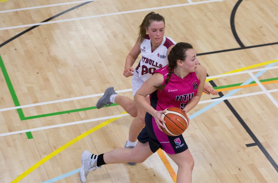 Female NTU Women's Basketball player with ball in hand