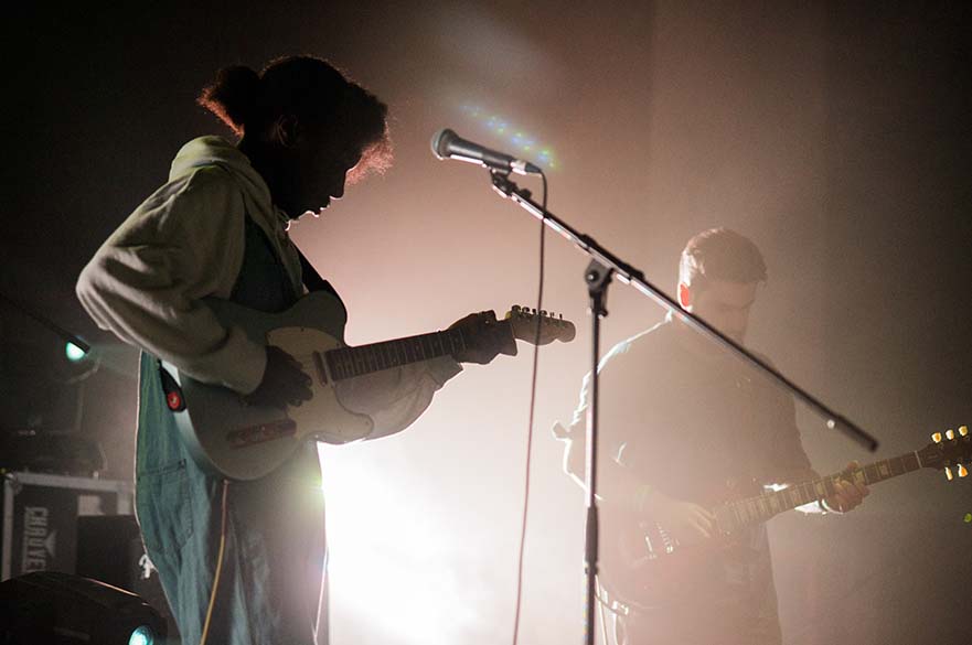 Two male students playing guitar