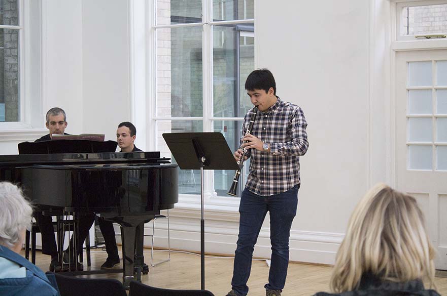 Male student playing clarinet
