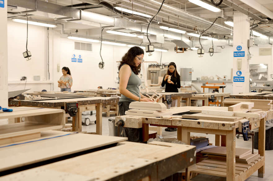 Students working on models on benches