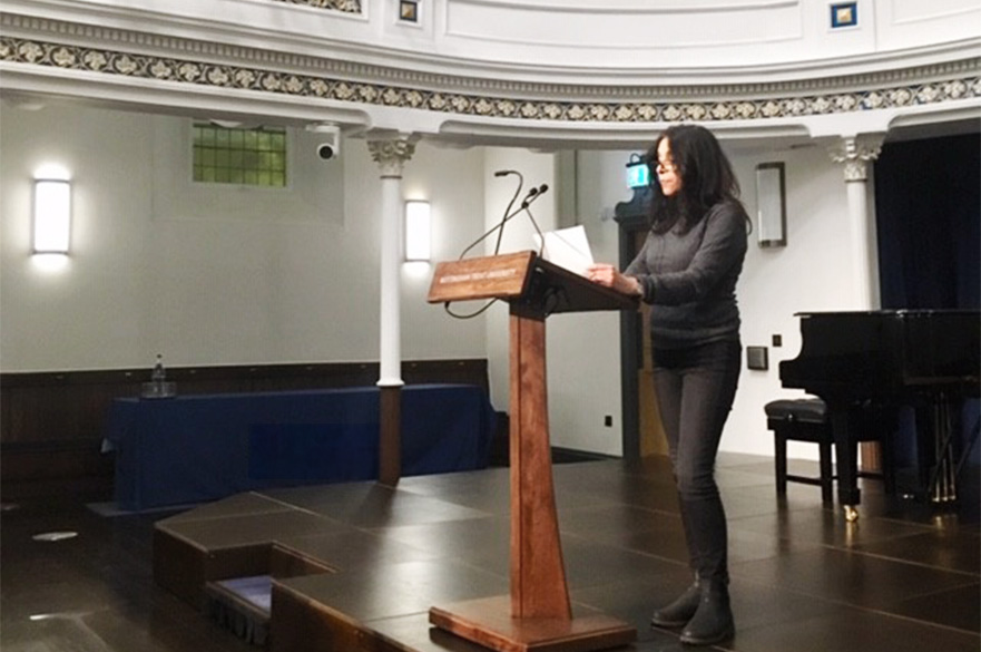Woman delivering a speech on a stage