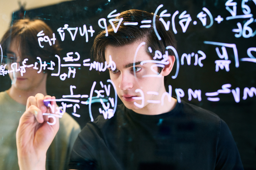 Image of student writing on maths board