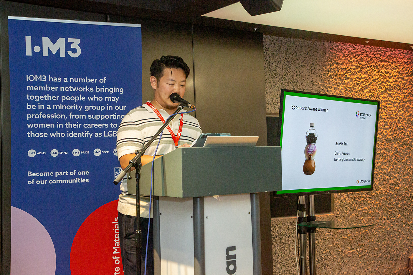 An NTU student collecting his award for a Bubble Tea bottle design