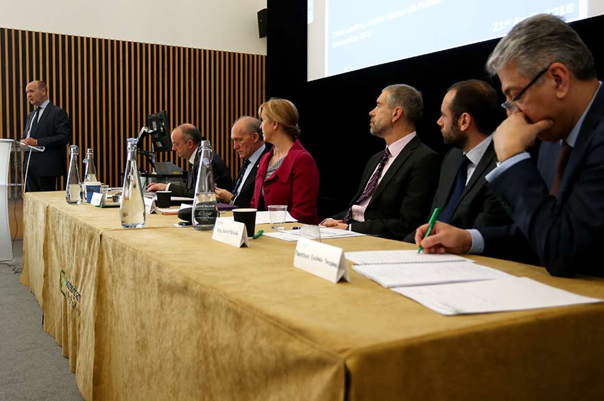 debate panel sat in a line behind table