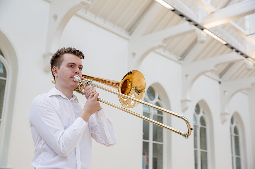 Male student playing trombone
