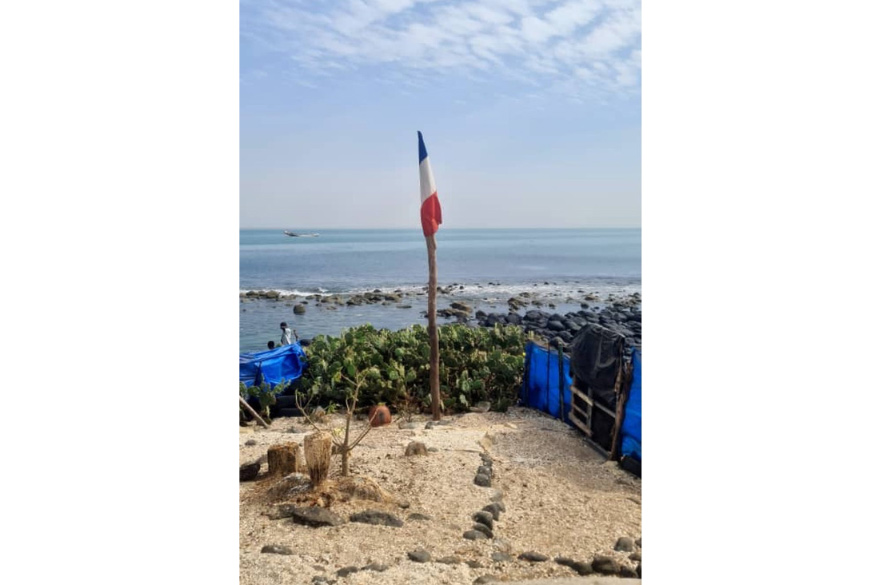 In Rufisque, Senegal, a French flag flies at full mast, not over a government building, but over a sacred site