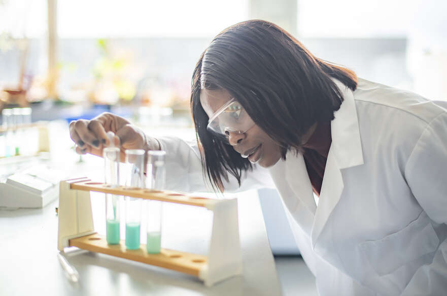 Student examining a testtube in a lab