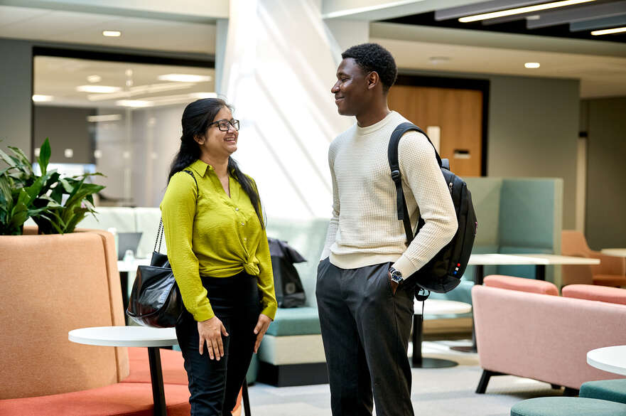 Two students talking in the PG centre