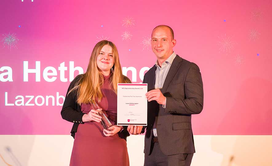 Laura Hetherington receiving her award on stage