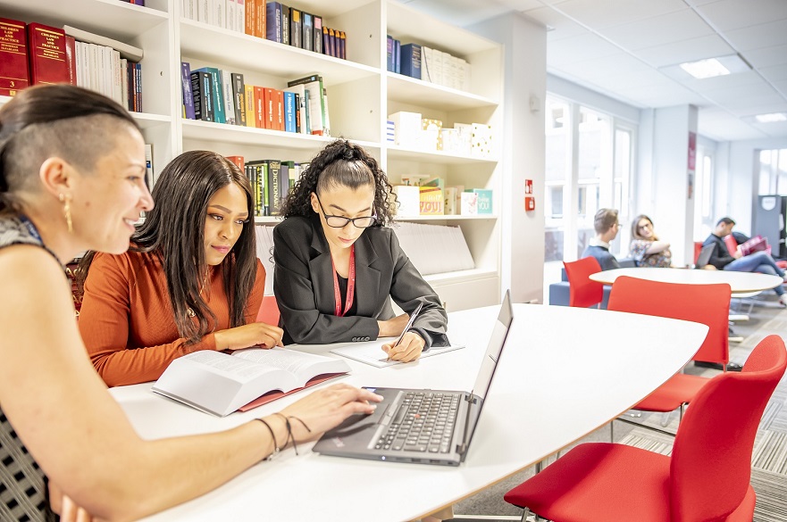 Students looking at law books at the NLS Legal office