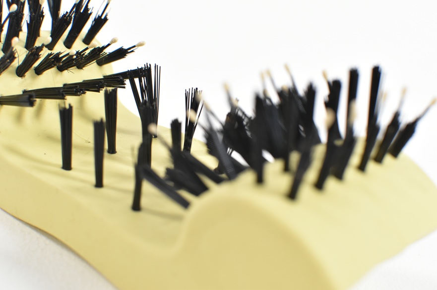 Close-up of a yellow hair styling brush.