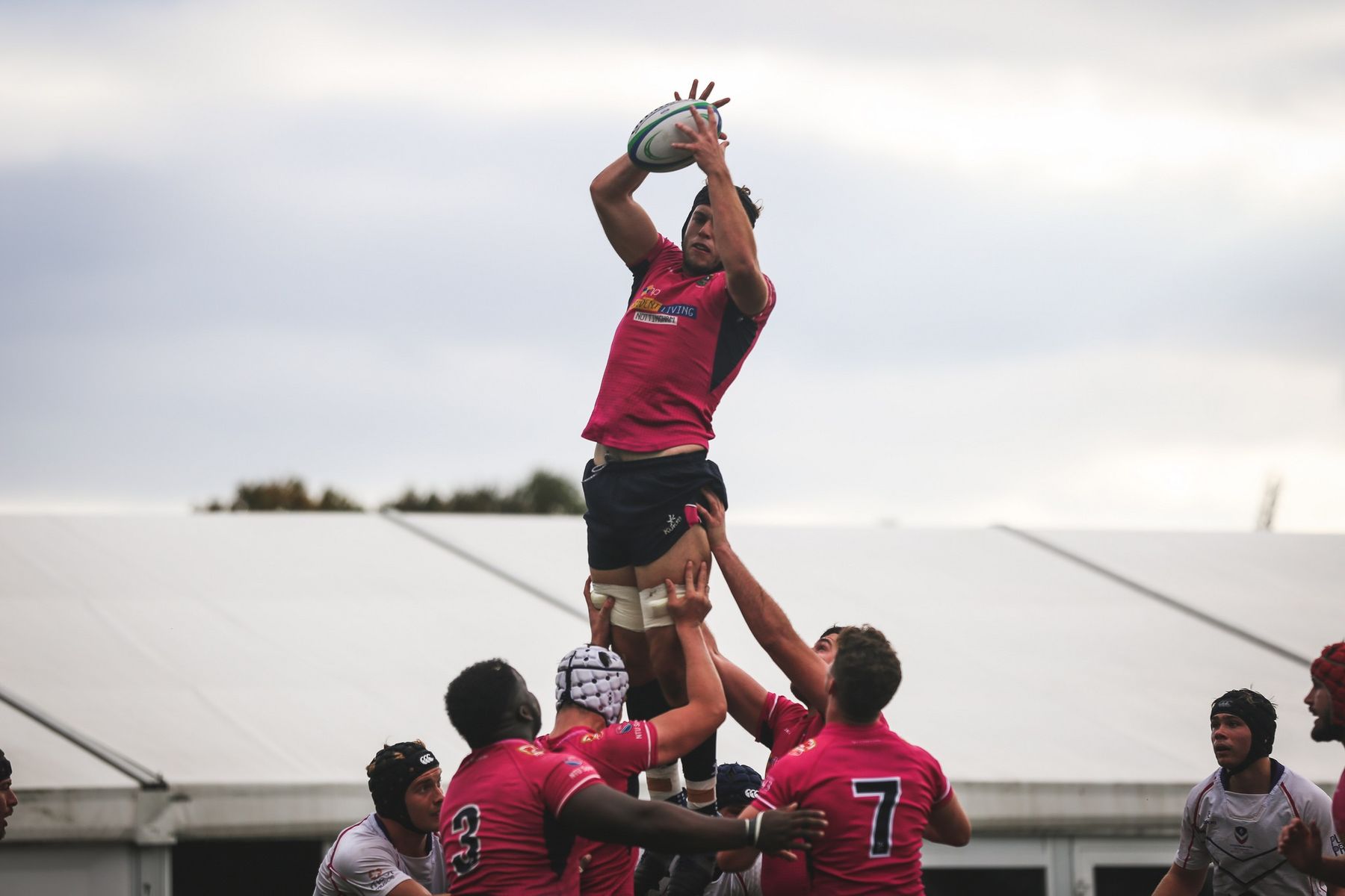 NTU Men's Rugby player goes up to catch the ball from a line out