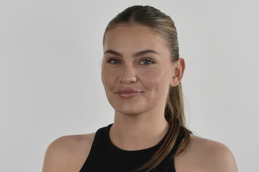 A person posing for a photo, smiling at camera.