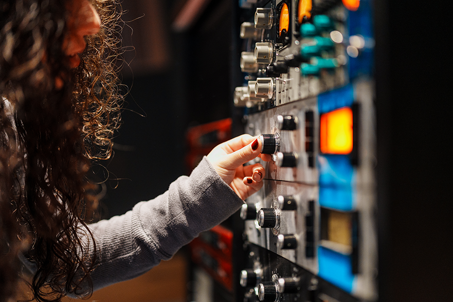 Student adjusting parameters on studio rack 