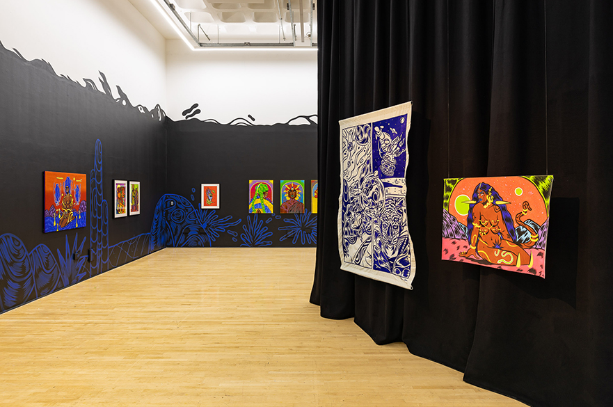 A gallery with black walls covered in coloured artworks.
