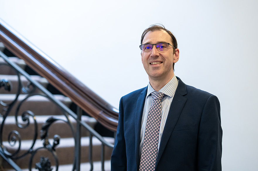 Rob Harding, a member of the Board of Governors, wearing formal attire and posing for a professional portrait
