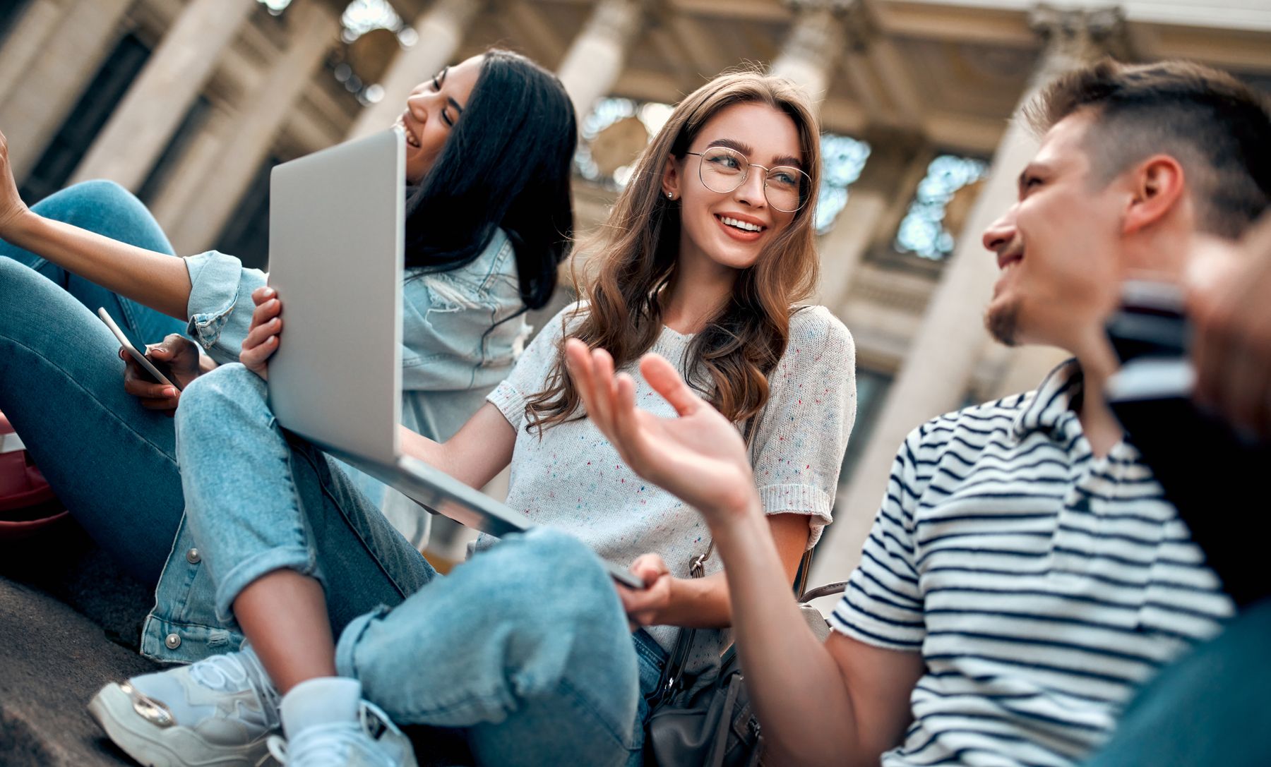 image of students sat on stairs